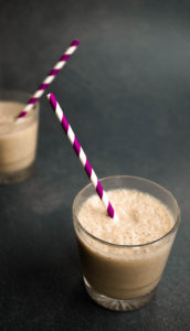 two glasses of pear smoothie with straws