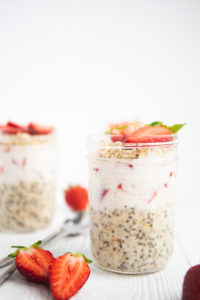 layers of overnight oats and strawberries in a jar